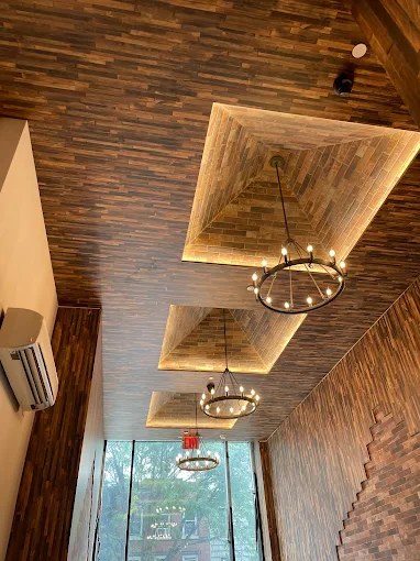 Ring chandeliers installed in a wood coffered ceiling