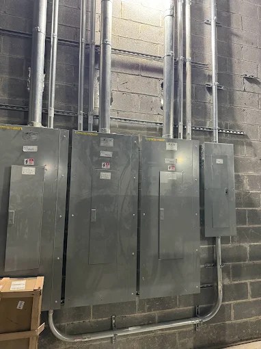 Bank of commercial panelboards with conduit risers installed