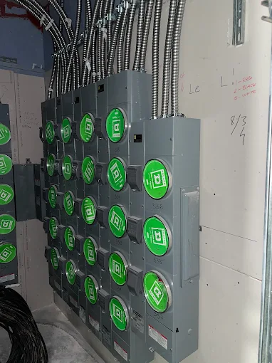 Multi-unit meter stack with new conduit feeders installed in a basement