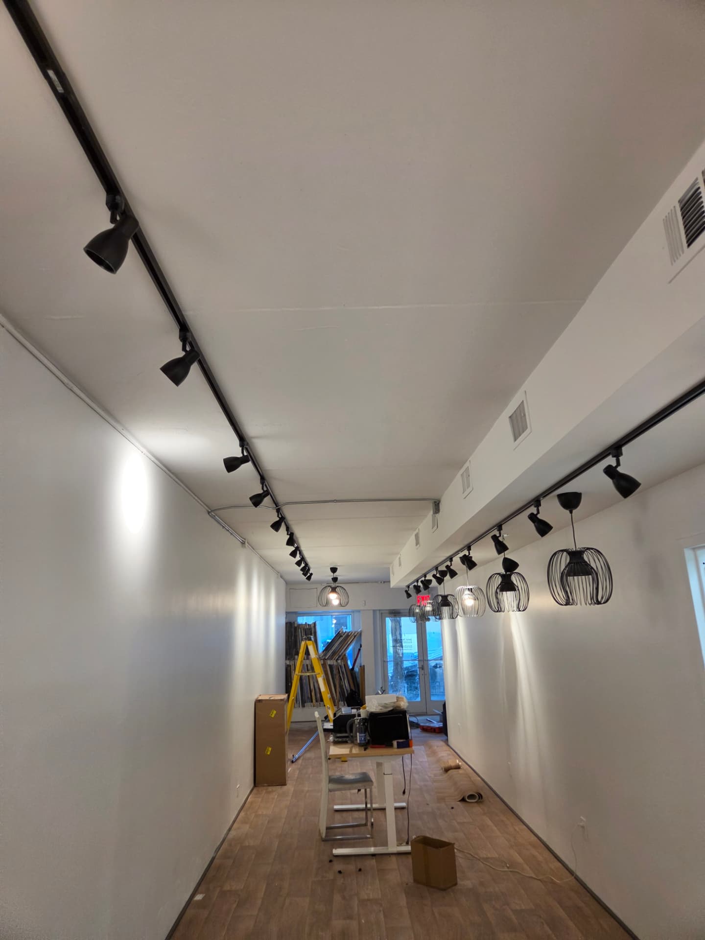 Track lighting and pendant lights installed in a commercial space