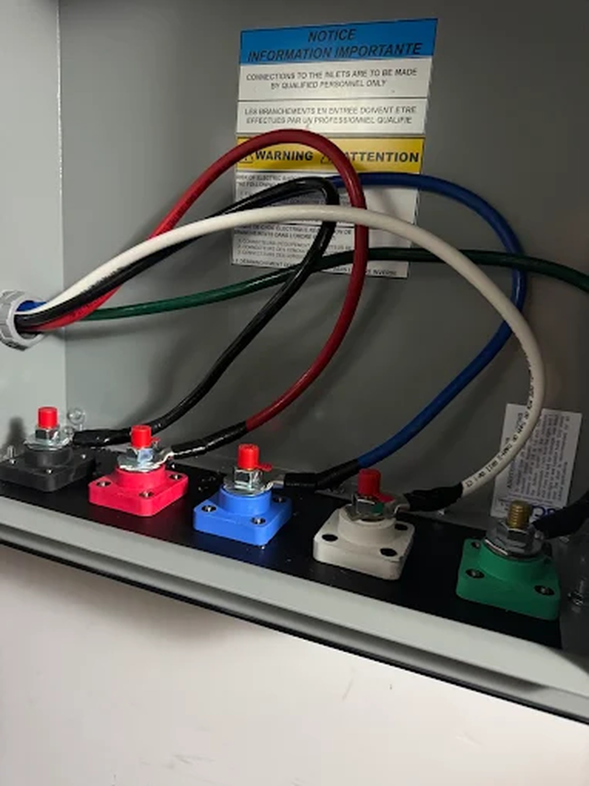 Color-coded service inlet lugs wired inside an enclosure