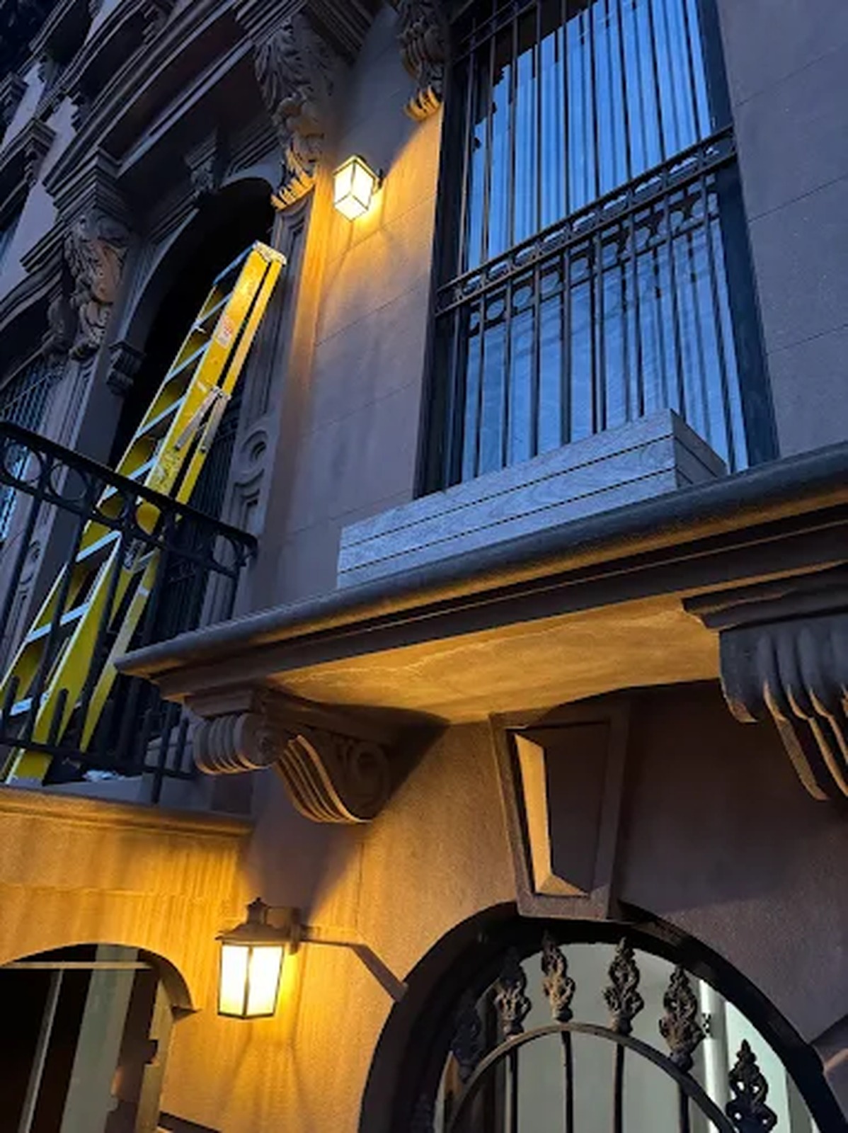 Exterior lantern fixtures installed on a Manhattan brownstone facade