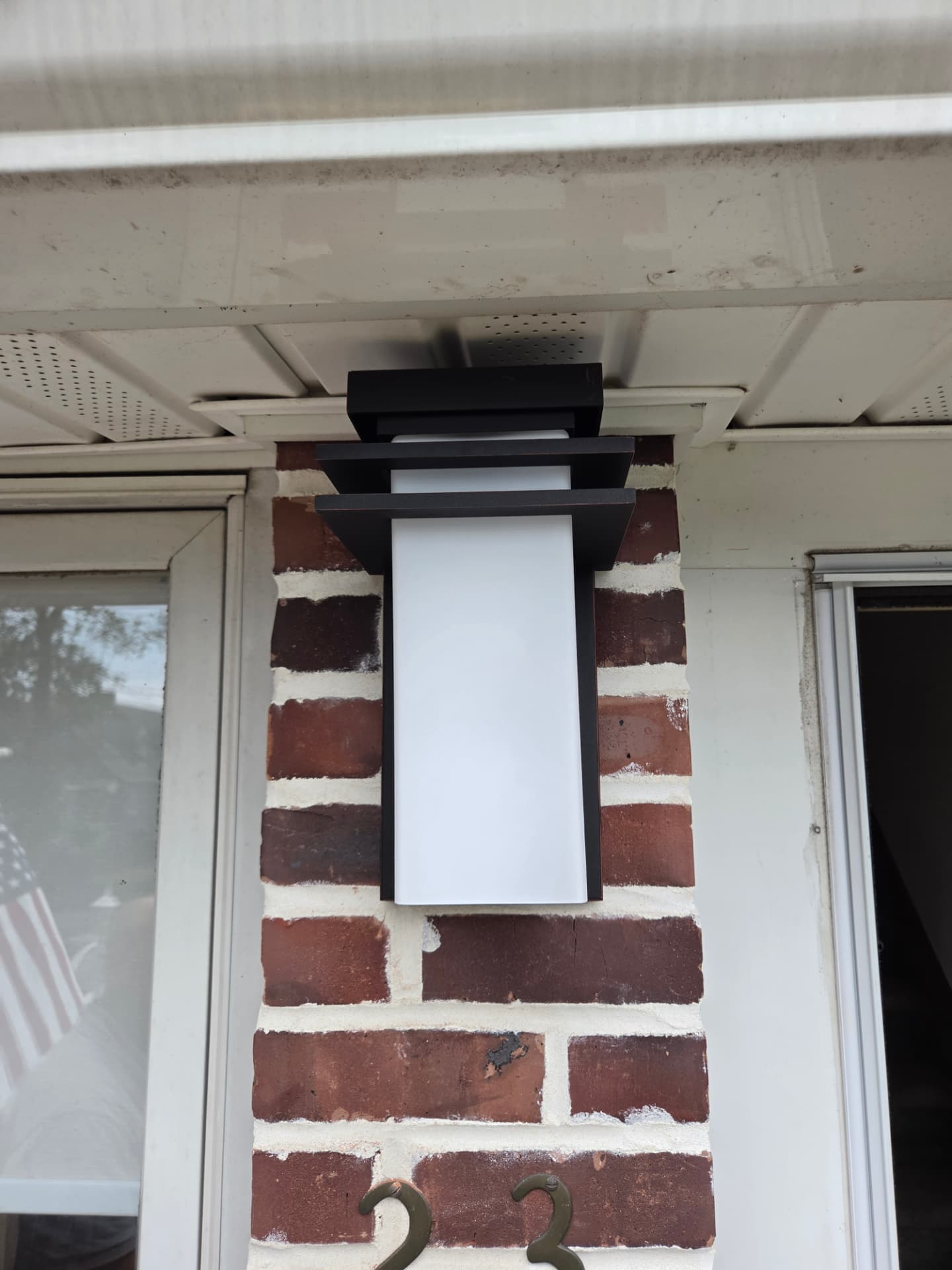 Modern outdoor wall sconce installed at a home entrance