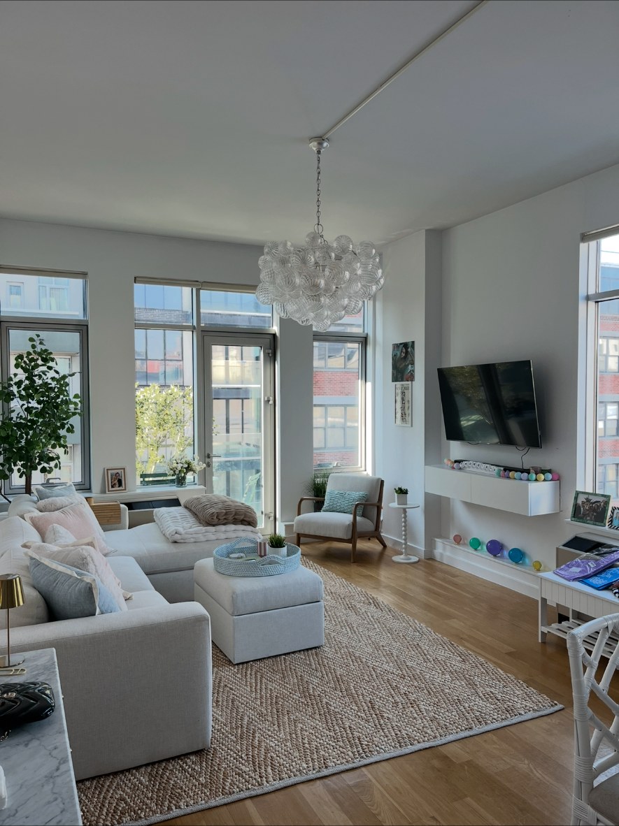 Glass globe chandelier installed in a bright living room