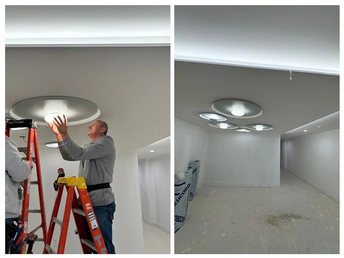 Recessed disc lighting and cove lighting installed in a new ceiling