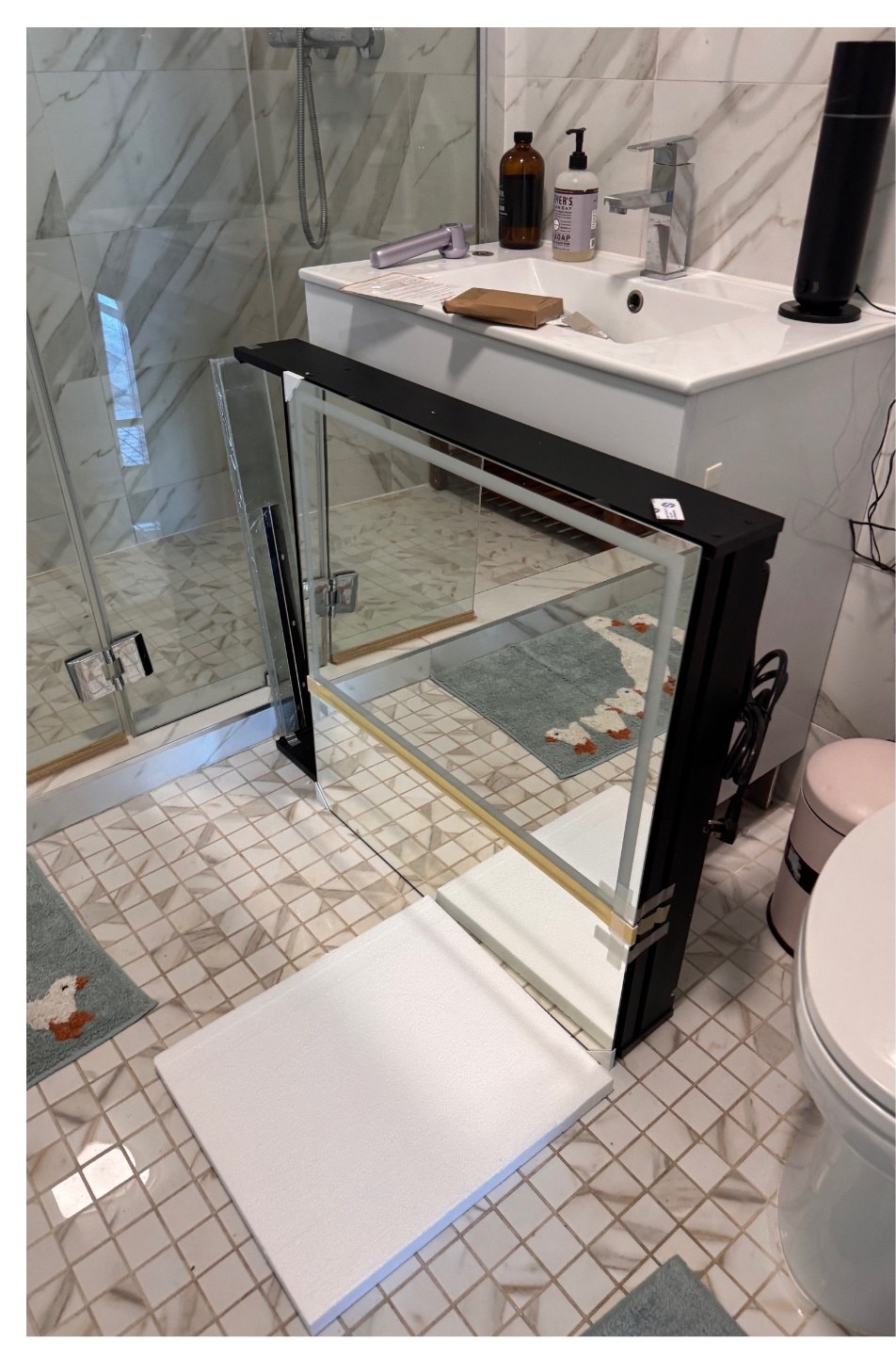 Backlit LED medicine cabinet prepped for wiring in a bathroom