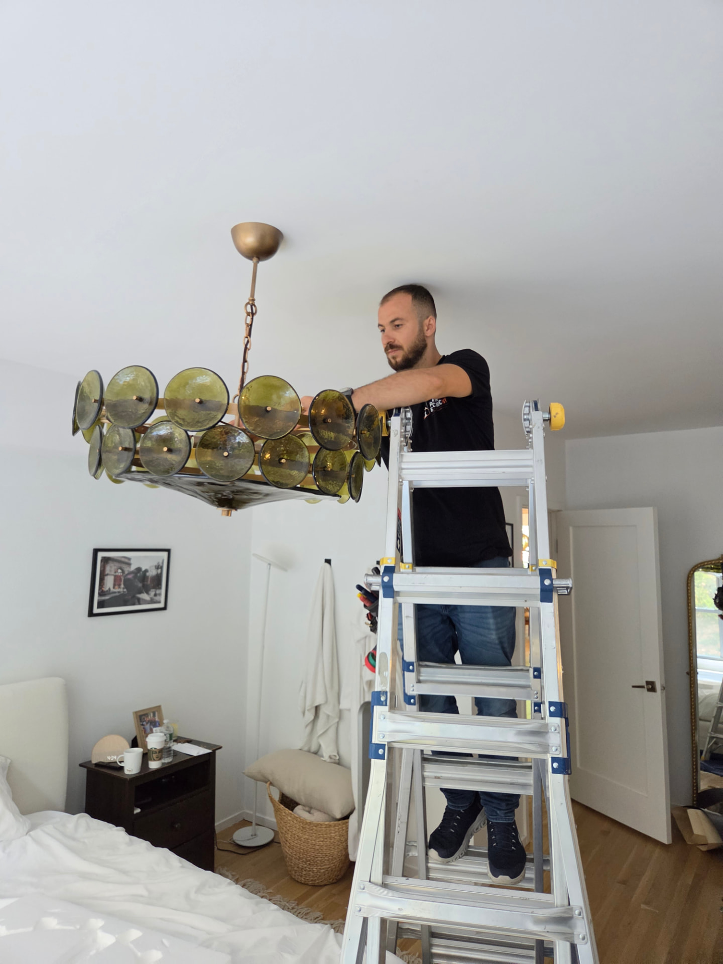 Installing a designer chandelier in a NYC bedroom