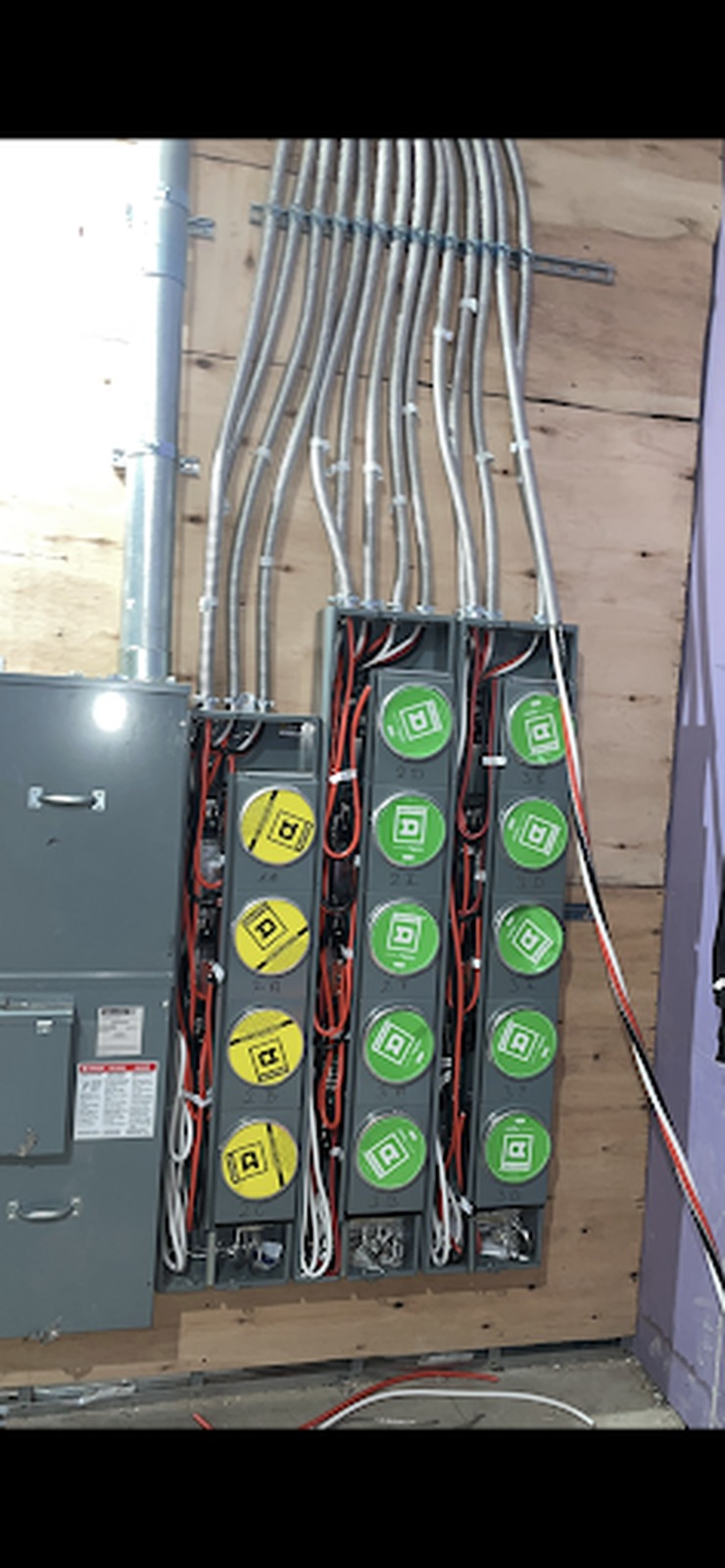 Fused disconnect and switch bank installed on a plywood backboard