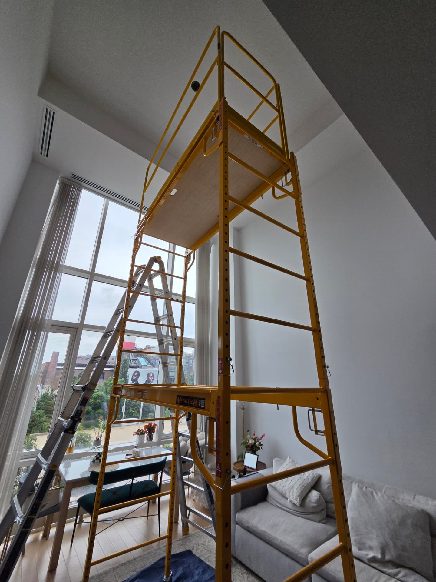 Scaffold set up for a high-ceiling light fixture installation